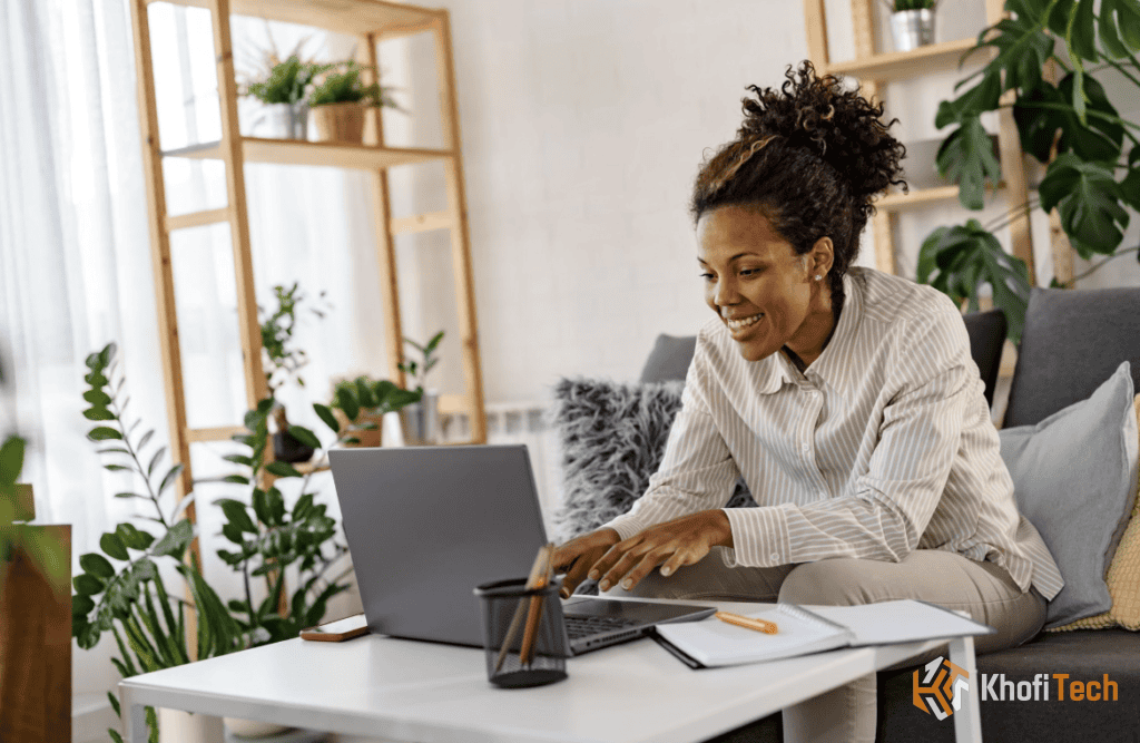 Happy woman working on laptop at home for online money making with AI tools.